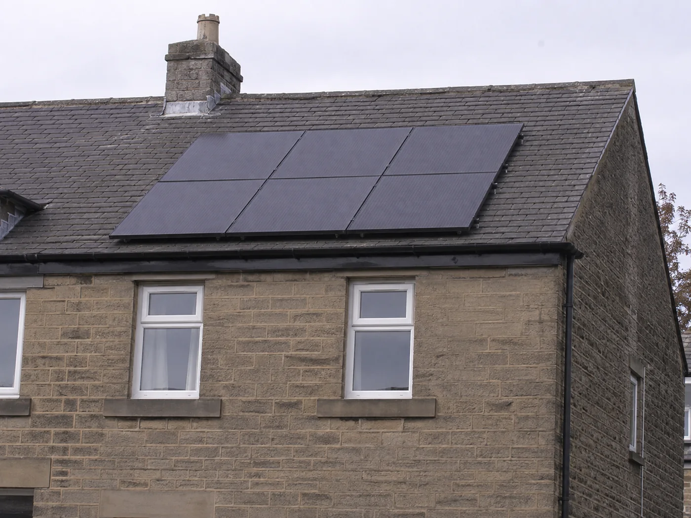 Solar panels on the slate roof of a stone built Leeds home